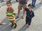 Children dressed in first responder outfits and National Night Out