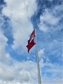 Photo of double red flags flying at the beach to indicate no swimming is permitted. 