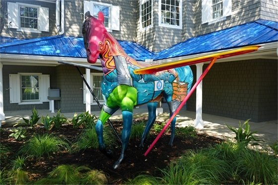 Town Hall just got a whole lot more vibrant with our newly unveiled public art fixture! We’re proud to reintroduce the Kill Devil Hills Centennial Horse, Pegasus, to the community! Huge thanks and recognition to local artist, Cliff Dunn, who undertook the task and beautifully captured the essence of our community on the Town's Pegasus. Cliff truly brought our Town's heartbeat to life through his art!  As you look at this community symbol, you will see periods of light, dark, local KDH landmarks and features, you will even see how our Town values education, which gives our community its wings.  Come by and check it out for yourself and get involved by snapping some pictures and tagging the Town. Together, let's celebrate the power of art to unite and uplift our community!