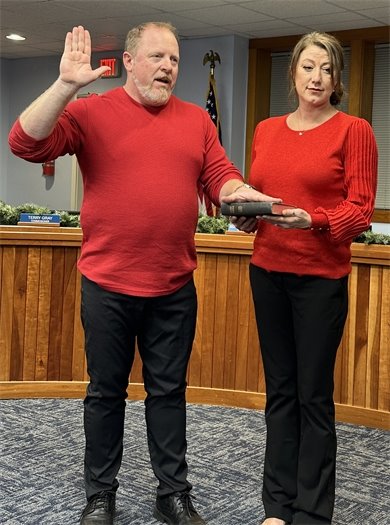 Commissioner BJ McAvoy, accompanied by his partner, takes his oath of office.