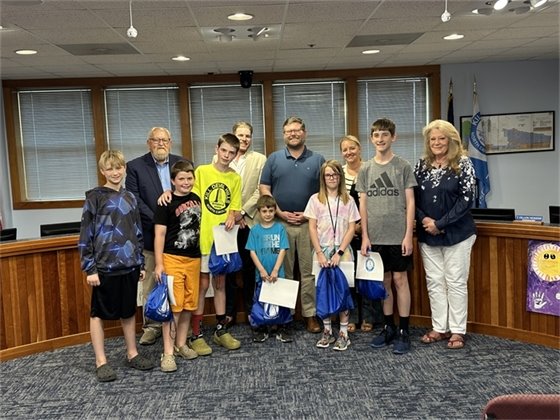 An image of the KDH Board of Commissioners with Trash Attack Chairperson and student artist who were recognized for their posters in the event's poster contest