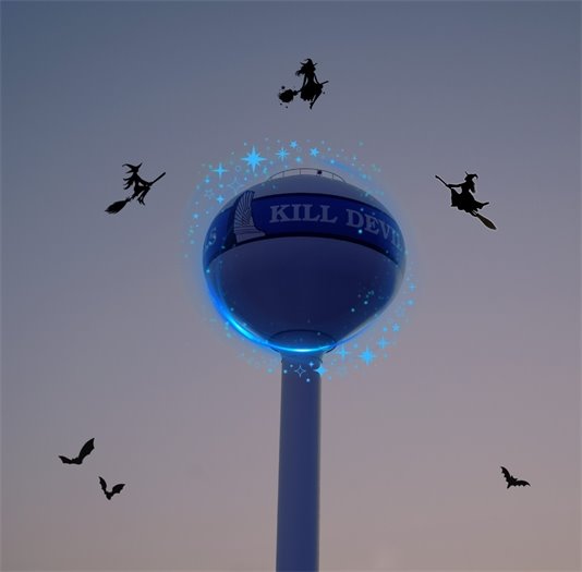 Happy Halloween image: KDH water tower with witches flying around it 