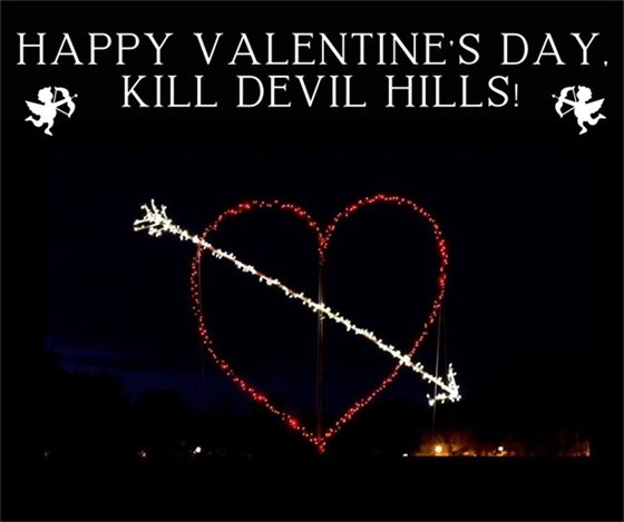 Image of a giant light-up heart on display at Aviation Park. Text reads: "Happy Valentine's Day, Kill Devil Hills"