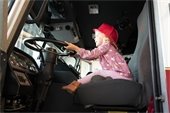 Child pretending to drive a firetruck at the recent open house event.